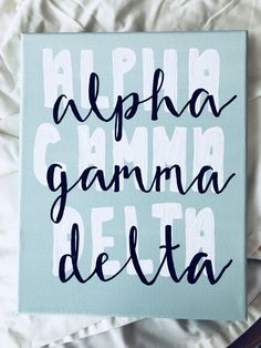 a blue canvas with the words alphabet gamma delta written in black ink on it