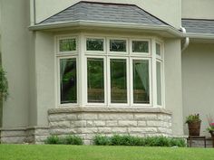 an advertisement for windows and doors on the front of a house