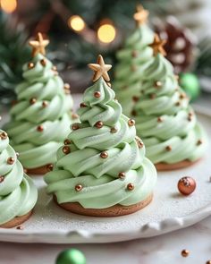 green frosted christmas tree cookies on a white plate