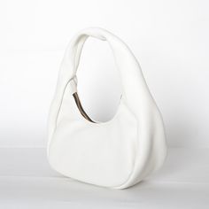 Crafted from buttery soft Italian leather, this shoulder bag features curved silhouette that rests comfortable under your arm. Petite in size, it has more than enough room for all your daily essentials. Shoulder bag with zip closure Fully lined interior 11in Wide x 12in High x 4in Deep Italian Buffalo Leather Made in USA Leather Hobo Bag With Round Handle For Errands, White Leather Hobo Bag With Zipper Closure, Versatile Soft Leather Baguette Bag For Errands, Chic Soft Leather Baguette Bag For Errands, Everyday Shoulder Bag With Round Handle And Zipper, Everyday Shoulder Bag With Zipper And Round Handle, Modern Soft Leather Baguette Bag For Errands, Chic Shoulder Bag With Soft Interior For Everyday, Soft Leather Baguette Bag With Double Handle For Errands