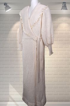 "Vintage knitted dressing gown/robe by Christian Dior. Large ribbed shawl collar, balloon sleeves and deep cuffs.  Two pockets and original belt. In good cared for condition. Size small on the label: Chest:  measures 21\" pit to pit, but does stretch a little if you need a larger size.  Most likely sized up for a voluminous fit. Nape to hem:  54\" Shoulder to cuff:  23.5\" Please ask if you have any questions :) Please note: this is a used item, not new and not pristine. My items have been in storage and may require laundering. If there is a problem with your order please contact me straight away - I always work with my customers to try and resolve any issues. Please read the item description and measurements carefully before bidding to try and limit the wastage created by returns in terms White Long Sleeve Winter Robe, Cream Long Sleeve Robe For Daywear, Elegant Winter Daywear Robe, Fitted Long Sleeve Winter Robe, Summer Dresses Uk, Knitted Shawl, Dressing Gown Robe, City Hall Wedding, 1940s Dresses