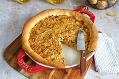 a pie sitting on top of a wooden cutting board