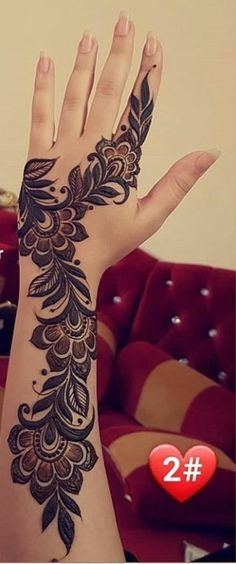 a woman's hand with henna on it and the number 2 in front of her