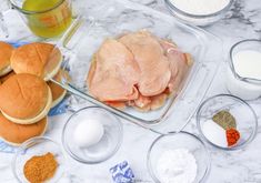 ingredients to make chicken burgers laid out on a counter