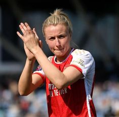 a female soccer player holding her hands together