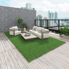 an outdoor living area with grass, couches and table on the deck overlooking cityscape