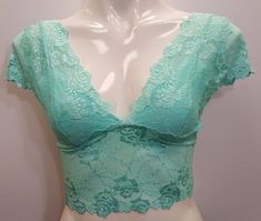 Stretch lace crop top cap sleeved short shirt blouse in light turquoise Aruba Blue color. Spring V-neck Lace Crop Top, Delicate Lace Fitted Crop Top, Spring Delicate Lace Stretch Crop Top, Lace Trim Crop Top, Lace Cropped Top For Spring, Fitted Cropped Lace Top For Spring, Fitted V-neck Crop Top With Lace Trim, Cropped Lace Top For Spring, Fitted Blue Lace Top For Summer