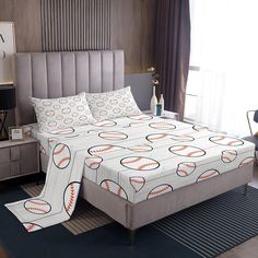 a baseball themed bed spread in a bedroom