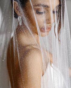 a woman wearing a veil and holding a cell phone