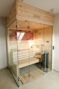 a sauna in a room with glass walls and wooden slats on the floor