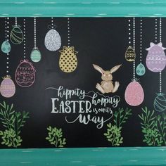 a chalkboard with an image of easter eggs hanging from it