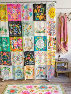 a colorful shower curtain covered in lots of different types of quotes and sayings on it