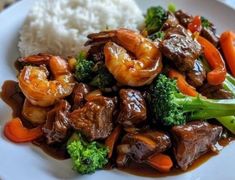 a white plate topped with meat and veggies covered in sauce next to rice