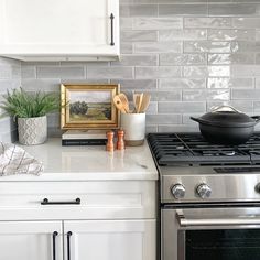 a stove top oven sitting inside of a kitchen next to a white cupboards and counter