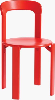 a red plastic chair sitting on top of a white floor