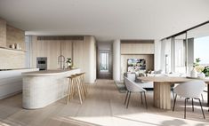 a kitchen and dining area with large windows overlooking the ocean in this modern apartment building