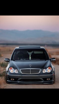 a car parked on the side of a dirt road