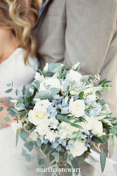 the bride and groom are holding their wedding bouquet