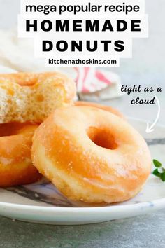 two glazed doughnuts on a plate with the words homemade donuts below it