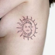 a sun and moon tattoo on the side of a woman's right breast is shown