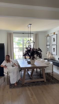 a woman sitting at a table in a living room