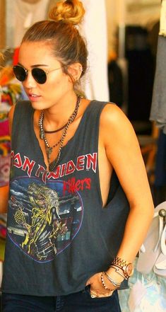 a woman wearing sunglasses and a tank top