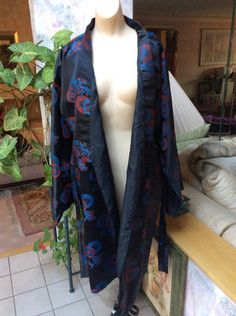 "Asian look robe/kimono without any labels. I recommend it for a lady who wears a size Medium in robes; my dress form is a size Small and I think you can see that the robe is a little roomy on the form. If you plan to wear it untied then it should fit perhaps up to a size 12 lady. I think the material is polyester but it could be silk with an acetate lining. It is a slinky flowing kimono but has a bit of weight because of the lining. The sleeves are long and wide in the kimono style; the sleeves Black Open Front Kimono For Festival, Black Open Front Kimono, Black Bohemian Robe With Kimono Sleeves, Bohemian Black Robe With Kimono Sleeves, Bohemian Long Black Robe, Bohemian Black Long Robe, Black Long Bohemian Robe, Long Black Bohemian Robe, Look Kimono