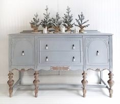 an old dresser with some plants on top