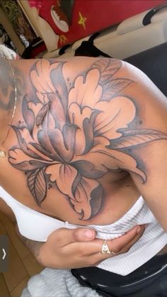 a woman with a flower tattoo on her back