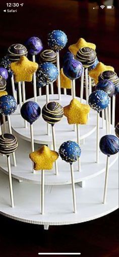 cake pops are arranged on top of each other in the shape of stars and planets