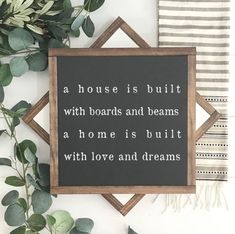 a sign that says, a house is built with boards and beams as home is built with love and dreams