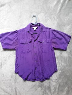 "100% washable silk camp shirt from Casual Corner. Color is more intense and to the red side of purple than photos show. Pic showing care tag is truer to color. Wear alone or layer with tank top. Buttons down center and on front pockets, short sleeves. Great condition; no tears or holes. Couple fade spots underarm seam. Tag states Medium, however it runs small. Measurements are taken flat and double where appropriate: Bust 40\" (taken from underarm seam, across shirt, to opposite seam) Arm openi Vincent Rebornica, Purple Shirts, Purple Clothing, Royal Purple Color, Concert Fit, Orange Outfit, Concert Outfits, Purple Outfits, Care Tag