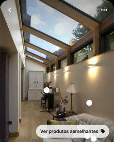 a living room filled with furniture under a skylight