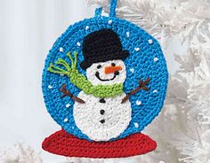 a crocheted snowman ornament hanging from a christmas tree with the text,