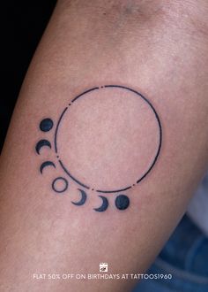 a woman's arm with a tattoo on it that shows phases of the moon