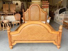 a bed frame made out of wicker and wood in a room filled with furniture