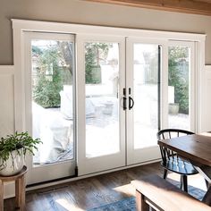 a dining room table and chairs with sliding glass doors