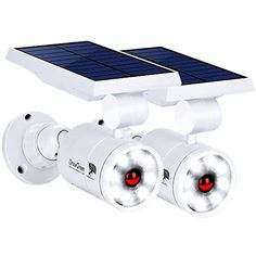 two white security cameras with solar panels on the top and one red light at the bottom