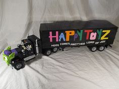 a toy truck with the word happytoz painted on it's side is shown in front of a white background