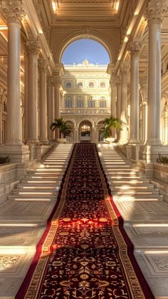 an elaborately decorated hallway with columns and arches in the center is lit by sunlight