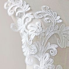 the back of a dress with white lace on it