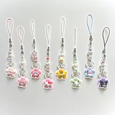 six key chains with different colored flowers on them