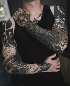 a man with tattoos on his arms and shoulder