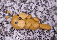 a yellow teddy bear laying on top of a counter