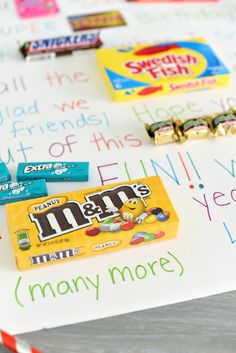 candy bar wrappers are laid out on top of a paper with words written in it