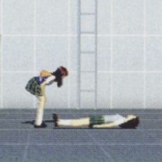 a person on the ground in front of a building with another person standing over it