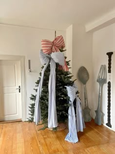 a christmas tree with bows on it in a room