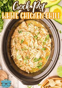 the crock pot white chicken chili in a crock pot with tortilla chips and avocado