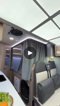 the interior of an rv with grey and white decor