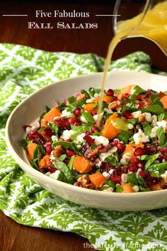 roasted butternut squash and barley salad is being poured into a white bowl on a green napkin